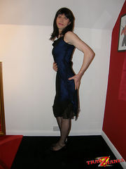 Crossdresser wearing a sultry blue dress and posing